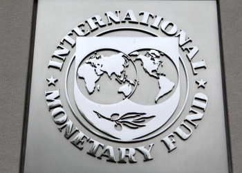 The International Monetary Fund (IMF) logo is seen at the IMF headquarters building in Washington, in this April 18, 2013 file photo. The IMF is expected to issue its semi-annual world economic outlook this week. REUTERS/Yuri Gripas/Files GLOBAL BUSINESS WEEK AHEAD PACKAGE - SEARCH "BUSINESS WEEK AHEAD JANUARY 18" FOR ALL IMAGES